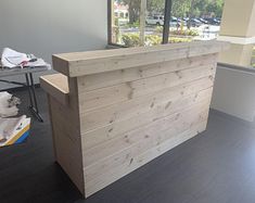 a wooden counter sitting in front of a window