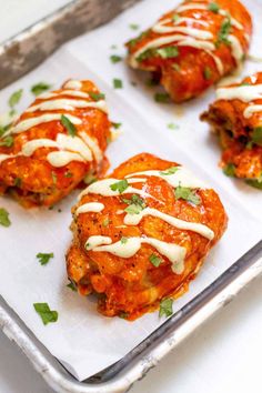 Sheet pan covered in parchment paper with four chicken thighs covered in buffalo sauce and drizzled with ranch. Easy Friday Night Dinner Ideas, Buffalo Chicken Thighs, Avocado Lime Ranch Dressing, Chicken Thigh Recipe, Bone In Chicken Thighs, Food Safety Tips, Baked Buffalo Chicken, Buffalo Wing Sauce, Hot Pepper Sauce