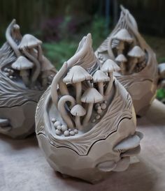 three ceramic mushrooms sitting on top of a table