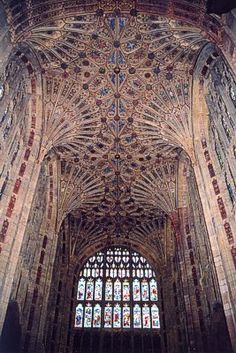 the inside of a cathedral with many stained glass windows and intricately designed ceilinging