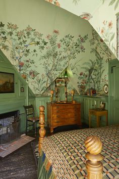 a bed room with a neatly made bed and a painting on the wall