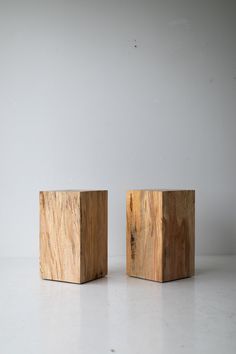 two wooden blocks sitting side by side on a white surface