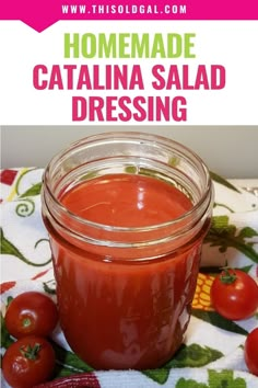 homemade catalina salad dressing in a jar on a table with tomatoes around it