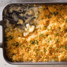 a casserole dish with cheese and green onions