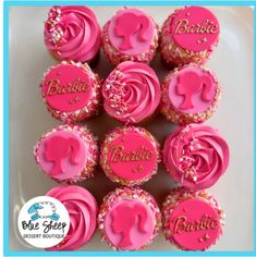 cupcakes with pink frosting and gold sprinkles are arranged on a plate