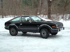 a black car is parked in the snow