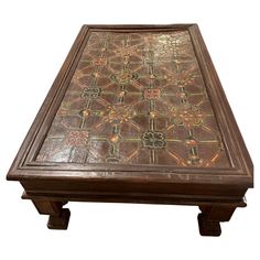 an old wooden table with intricate designs on it