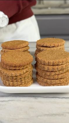 a white plate topped with cookies on top of a counter