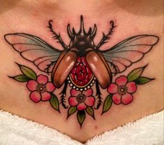 a woman's stomach with a bee and flowers on the side, tattoo style