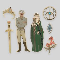 some brooches and pins are laying out on a white surface with an image of two people