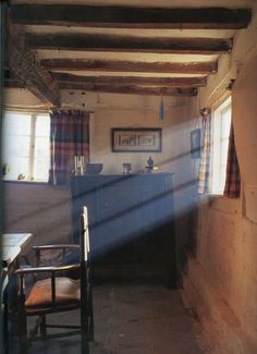 the interior of an old house with wood beams and exposed ceiling, blue counter tops