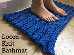 a person standing on top of a blue crochet bath mat