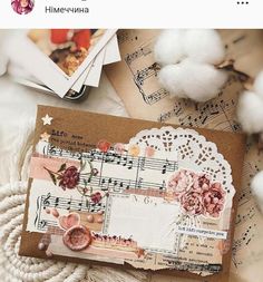 an image of a card with flowers and music notes on the front, surrounded by cotton balls