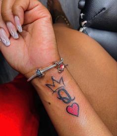 a woman's arm with a tattoo that says mom and heart on the wrist