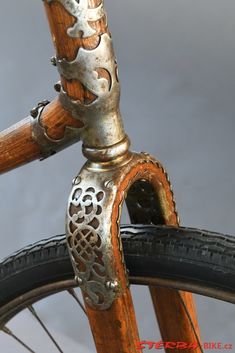 an old bicycle with ornate details on the front wheel