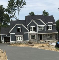 a house under construction with a boat in the driveway