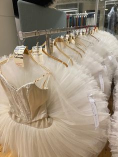 there are many dresses on display in the store