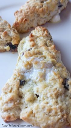 three scones on a white plate with blueberries