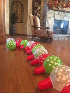 a group of plastic balls sitting on top of a wooden floor next to a fire place