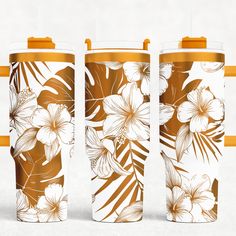 three travel mugs with floral designs on them, one yellow and the other white