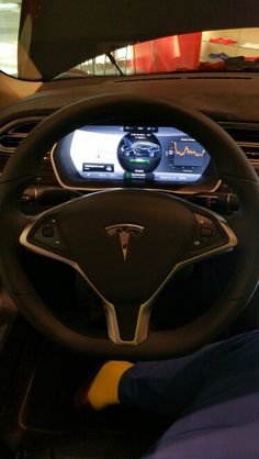 the interior of a car with an electronic display on it's dash board and steering wheel