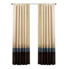 the curtains are hanging in front of a white wall with black and brown trims