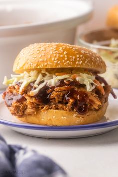 a pulled pork sandwich on a bun with cole slaw