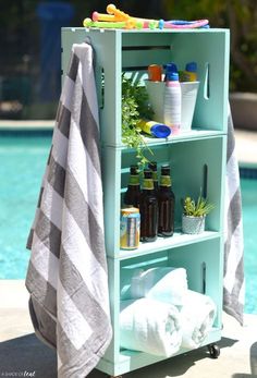 a towel is hanging on the side of a shelf next to a pool with bottles and towels