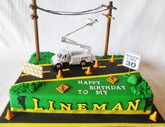 a birthday cake for a construction worker on top of a road with trees and signs