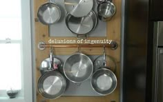 pots and pans are hanging on the wall