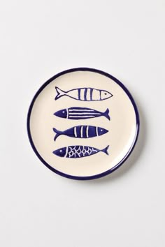 a white plate with blue fish on it