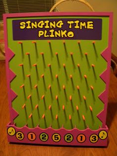 a pink and green sign that says singing time plinko with candles in it