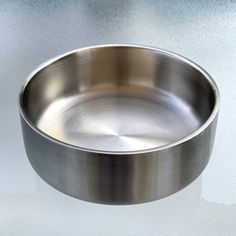 a metal bowl sitting on top of a table