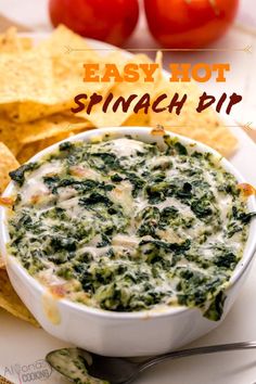 spinach dip in a white bowl surrounded by tortilla chips