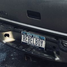 a license plate on the back of a car that says new york, rebellious boy