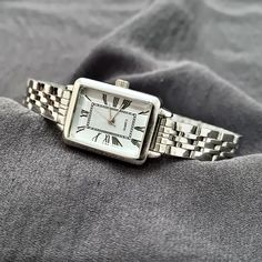 Woman Wrist Watch, Silver Colour Watch, Roman Numeral Dial, Rectangle Design Watch, Modern Design Watch, Adjustable Band, White Dail, Gift for Her, Mother's Day Gift, Valentine's Day Gift, Present for Her, Daily Usage, Christmas Gift Diamensions: - Case Thickness: 9 mm - Case Diameter: 25 mm x 20 mm - Band Width: 12 mm - Weight: 50 gr Timeless Rectangular Watch With Adjustable Fit, Timeless Adjustable Rectangular Watch, Classic Square Watch As A Gift, Classic Square Watch Accessories For Gifts, Classic Square Watch As Gift, Classic Square Watch For Gifts, Classic Square Watch For Gift, Square Watch With Metal Dial For Gift, Gift Square Watch With Metal Dial