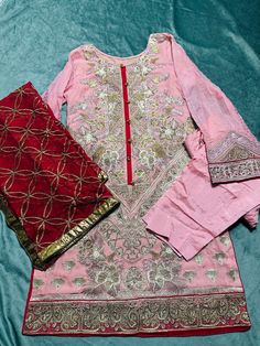 size:Medium  Heavy embroidered Stitched 3piece dress. Shirt: front heavy embroidered and embroidered on back & design on sleeves and shirt bottom. Dupatta: heavy embroidery on chiffon  bottom:straight plain pant No return or exchange please. Note:Please contact me if you have any problem with your order. Designer Dresses With Floral Embroidery For Eid, Chanderi Floral Embroidered Dress For Eid, Designer Chanderi Dress With Floral Embroidery, Pink Chanderi Dress With Intricate Embroidery, Eid Chanderi Dress With Floral Embroidery, Semi-stitched Embroidered Lawn Suit, Anarkali Cambric Kurta For Party, Elegant Red Unstitched Suit With Floral Embroidery, Red Unstitched Suit With Floral Embroidery For Eid