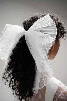 Pleated Tulle Hair Bow by TEMPÊTE | Modern Bridal Brand | Based in Canada | Ship Worldwide. Looking for an ethereal nod to make your wedding day unique to you? Our Pleated Tulle Hair Bow makes a loud statement for the daring bride looking for layers of tulle alongside a dramatic wedding dress. Perfect for bachelorettes, engagement dinners, after party, you name it! Shop Now. bridal bow tie, modern bridal bow, wedding accessories, bride hairpiece accessories, bridal bow detail, bridal hair bow Modern Wedding Hair, Bridal Hair Bow, Wedding Hair Bow