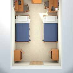 an overhead view of a room with two beds and a desk in the corner,