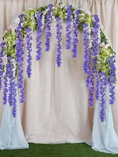 purple and green flowers are hanging from the ceiling