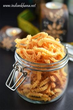 a glass jar filled with fried food on top of a table