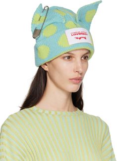 Rib knit lambswool-blend beanie in blue. Exposed seams and jacquard polka-dot pattern in green throughout. · Graphic appliqués with safety-pin hardware at crown · Logo patch at face · Rolled brim · Concealed logo hardware at back face · Silver-tone hardware Available exclusively at SSENSE. Supplier color: Light green/Light blue Cute Fashion Accessories, Charles Jeffrey Loverboy Beanie Outfit, Loverboy Beanie, Fancy Photoshoot, Beanie Outfits, Charles Jeffrey Loverboy, Charles Jeffrey, Designer Beanies, Strapless Ruffle Dress