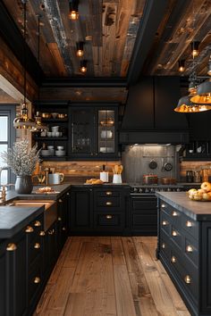 a kitchen with black cabinets and wooden floors is lit by pendant lights that hang from the ceiling