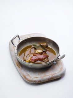 a metal pan filled with meat and vegetables