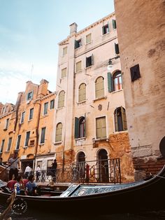 a gondola is parked in front of an old building