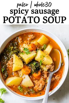 a bowl of soup with potatoes and meat in it on top of a white table