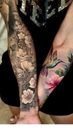 a woman with tattoos on her arms and arm is holding onto the hands of another person