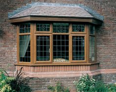 a brick building with three windows and a tiled roof