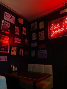 a restaurant with red neon signs on the wall and white chairs in front of it