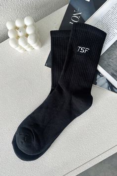 Millie Socks are designed to provide optimal comfort and style. They offer mid-calf coverage and ribbed ankles that add an extra touch of style. The iconic TSF logo is featured prominently to provide a chic look to any outfit. Black Ribbed Stretch Socks, Black Stretch Ribbed Socks, Casual Mid-calf Ribbed Socks, Trendy Black Socks For Winter, Black Socks For Fall Streetwear, Trendy Black Winter Socks, Black Fall Streetwear Socks, Black Casual Socks For Spring, Casual Black Socks For Spring